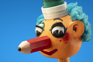 Mr Squiggle puppet head, with a pencil for a nose.