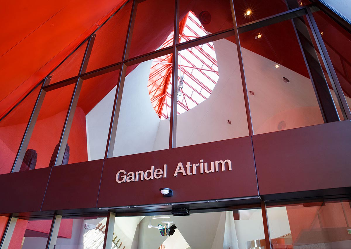 The entrance to the National Museum of Australia's building. Above the door, there's large signage in white spelling 'Gandel Atrium'.