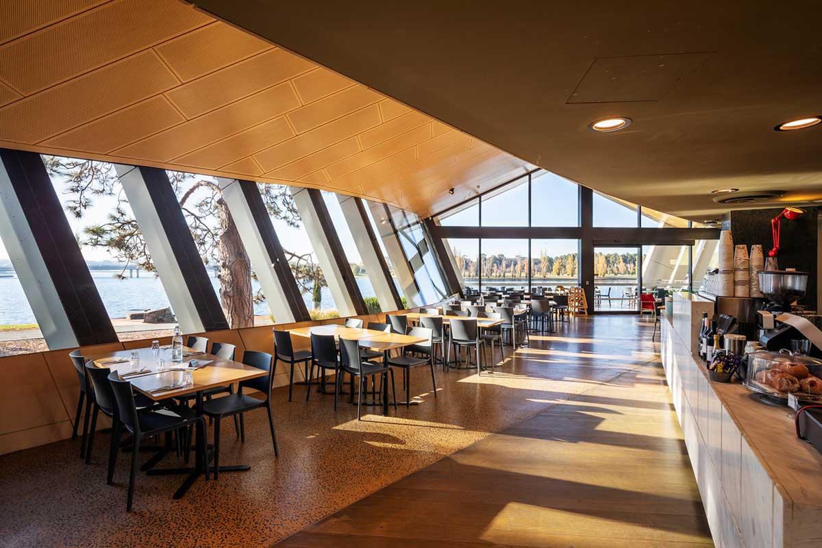 Cafe at the National Museum of Australia, with rows of tables and chairs beside large, light-filled windows.