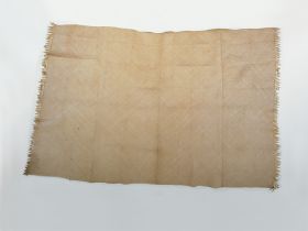 Mat made of diagonally plaited light yellow leaf strips, by alternately placing one stripe with the glazed side of the leaf up and the other with the unglazed side up.