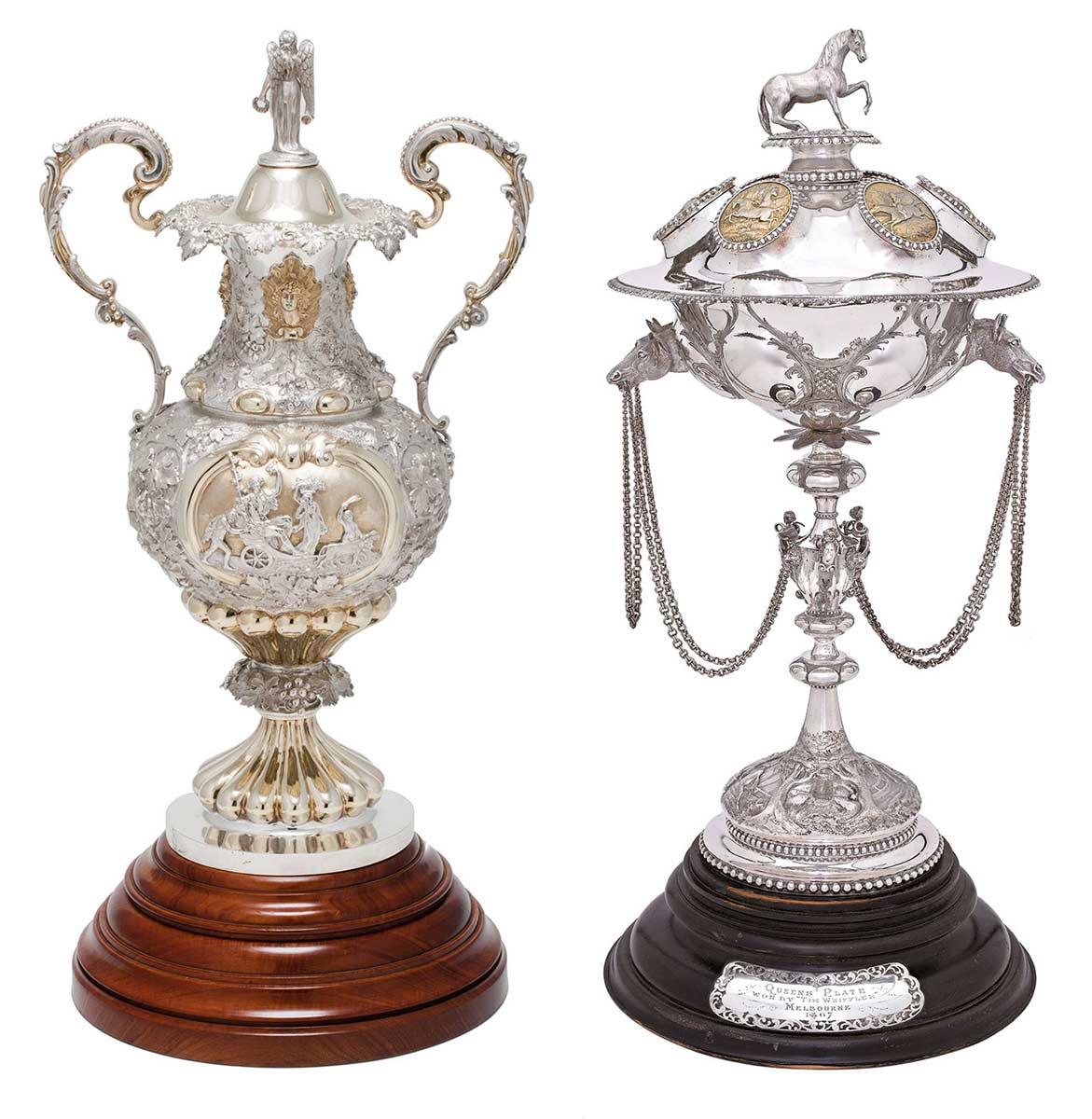 The Melbourne Cup trophy is mostly silver with two ornate handles and mounted on a wooden base. The Queen's Plate trophy has a horse on the top standing a rounded silver globe mounted on a long stem. Chains are draped from the globe.